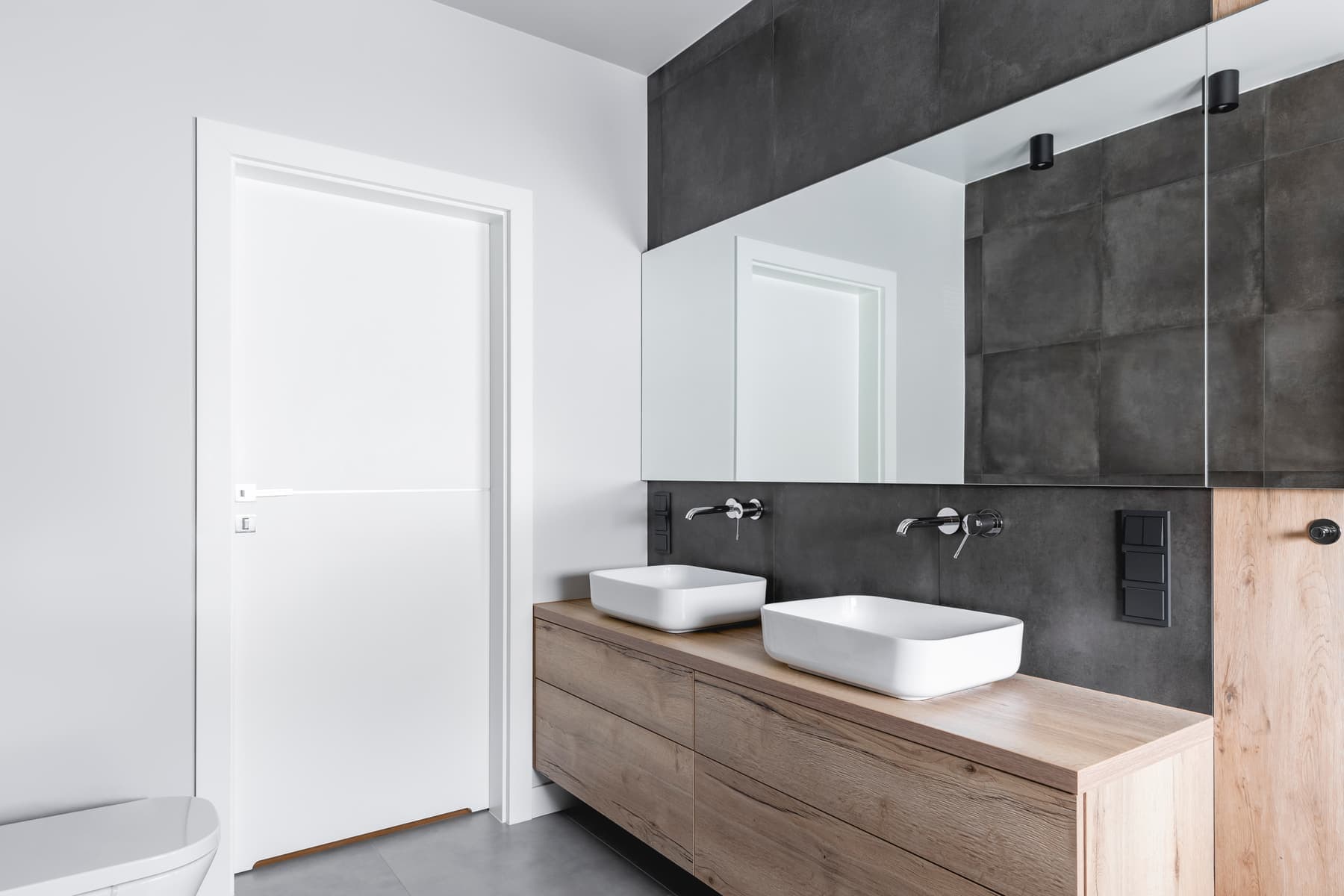 Modern bathroom with a wood double vanity and vessel sinks