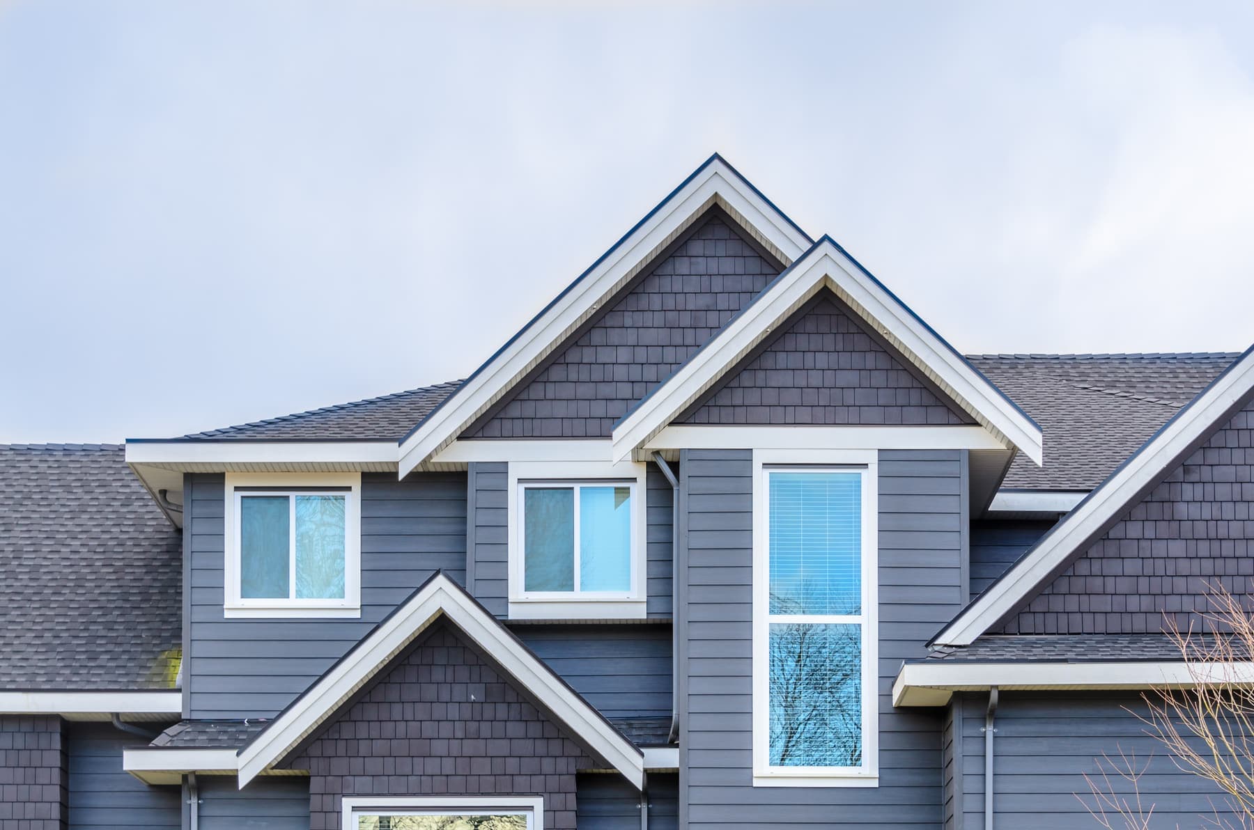 Two-story home with freshly painted gray siding and white trim