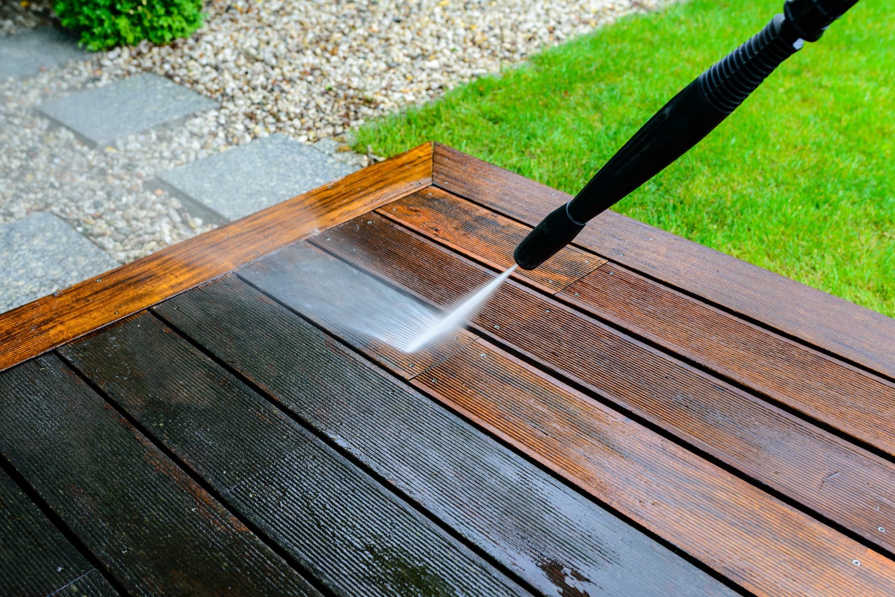 Pressure washing weathered deck boards back to bare wood